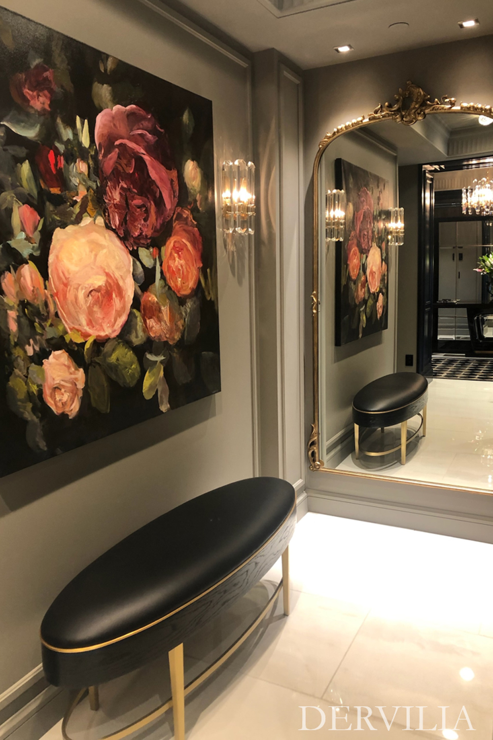 Large floral painting displayed in an elegant interior vignette with an ornate framed mirror, wall sconces, and a curved upholstered bench, highlighting Dervilia’s approach to art curation and refined spatial storytelling.