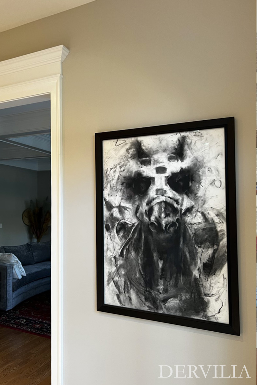 Large monochrome artwork installed on a transitional interior wall, using contrast and scale to create a focal point between adjoining living spaces.